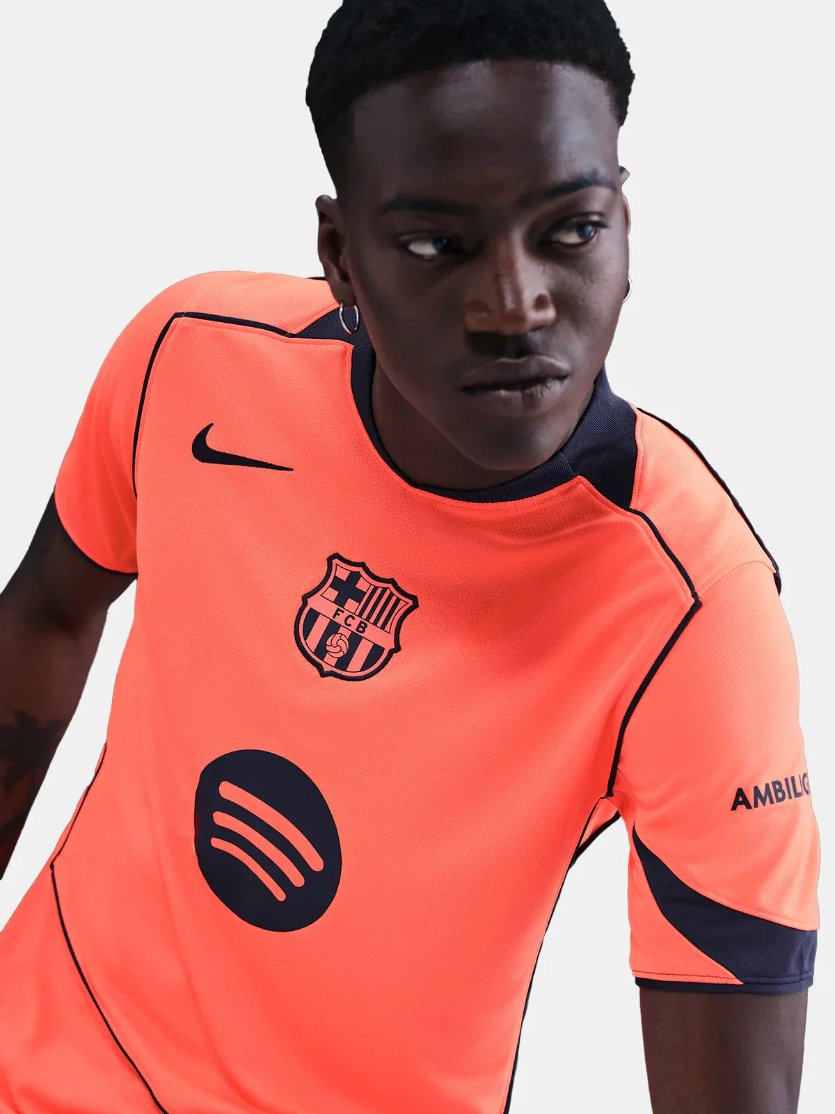 FC Barcelona 25/26 third training jersey in bright orange with black accents