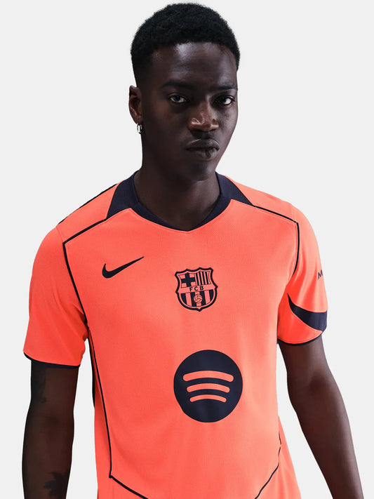 FC Barcelona 25/26 third jersey in bright orange with navy accents